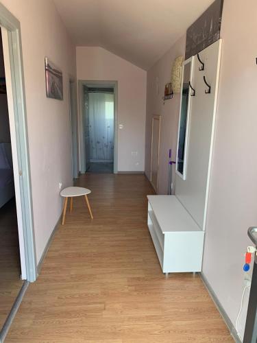 an empty room with a staircase and a table at R i A N A 2 in Eforie Sud