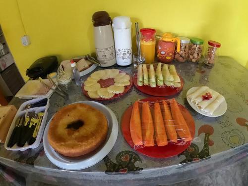 a table topped with food and a donut on a table at Pousada do Bentinho in Atins
