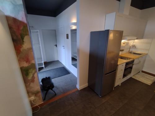 a kitchen with a large stainless steel refrigerator at Apartament Łoś i Ryś in Zła Wieś Wielka