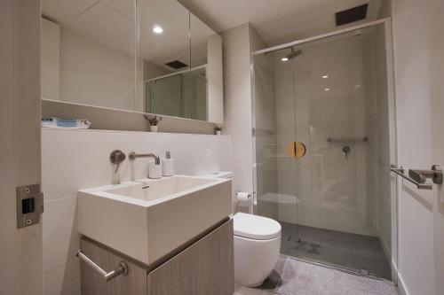 a bathroom with a sink and a toilet and a shower at King Bed Luxury CBD Coastal Room with Amazing City Views, Spa, Gym, BBQ, Steam & Sauna Rooms in Adelaide