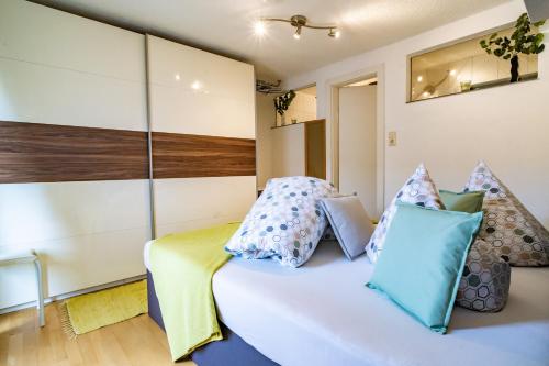 a bedroom with a bed with pillows on it at Haus Berghof in Gries am Brenner