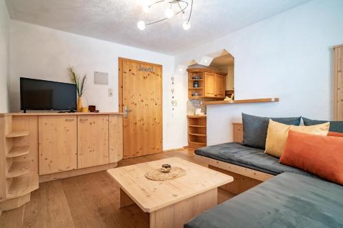 a living room with a couch and a table at Haus Berghof in Gries am Brenner
