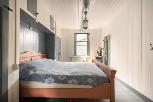 a bedroom with a bed with a blue comforter at Private Characteristic farmhouse near the lake in Andijk