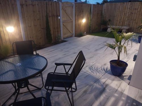 a patio with a table and chairs and a fence at Sam's retreat in Hayle