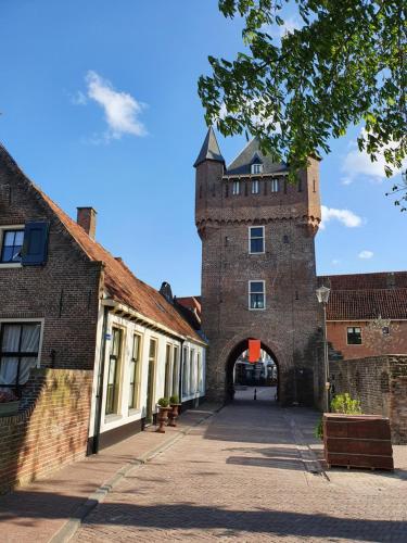 a building with a tower in the middle of a street at Hausboot Lucky in Hattem