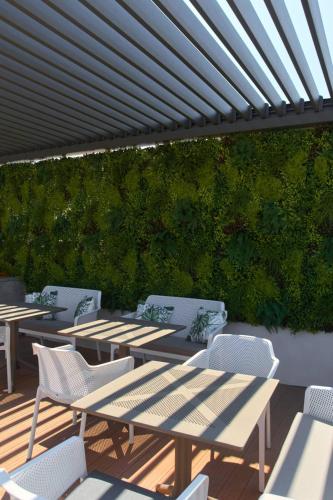 a group of tables and chairs on a patio at 7Rizes Luxury Living in Heraklio Town