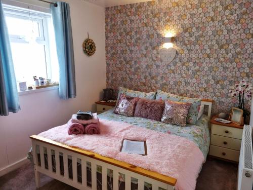 a bedroom with a bed with a teddy bear on it at Tiffy's Place in Blackpool