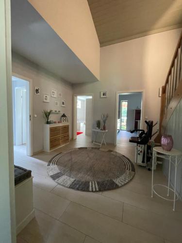 a large living room with a large rug on the floor at Ferienhaus Nicole II, Barrierefrei, mit HIRO Lift in Quedlinburg
