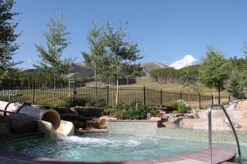 a swimming pool with a water slide in a garden at Grand Lodge on Peak 7 in Breckenridge