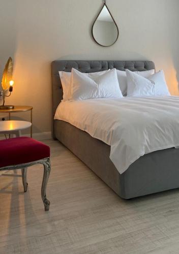 a bedroom with a bed and a table and a chair at Tagoo Vama Veche in Vama Veche