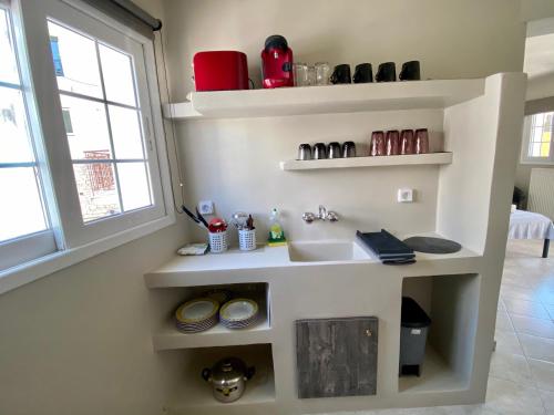 a kitchen with a sink and a window at Pelagias Apartments in Agia Effimia