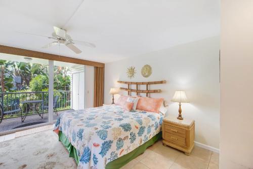 a bedroom with a bed and a balcony at Cliffs 5205 Condo in Princeville