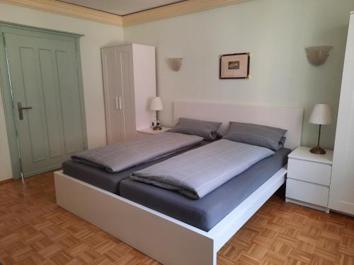 a bedroom with a large bed with blue sheets at Alte Bahnhofstraße 12 in Karlstadt