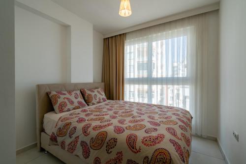 a bedroom with a bed and a large window at Sare Suites Downtown in Antalya