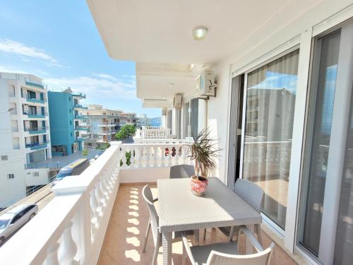 a balcony with a table and chairs on a balcony at Parid Appartments in Sarandë