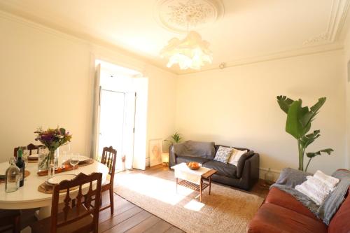 un soggiorno con un divano e un tavolo di Chalet Santa Rita - STUNNING APT. NEXT TO THE SEA a Estoril