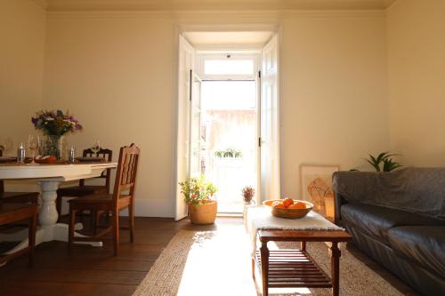a living room with a couch and a table at Chalet Santa Rita - STUNNING APT. NEXT TO THE SEA in Estoril