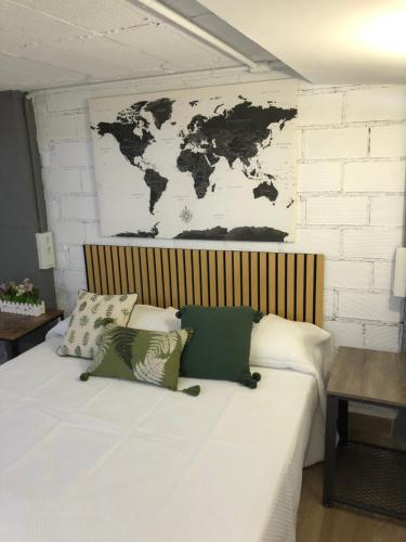 a bedroom with a bed with a map on the wall at Loft 2 , San Ignacio Maracena in Maracena