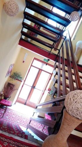 a spiral staircase in a room with a window at Hotel Rosalpina in Serina