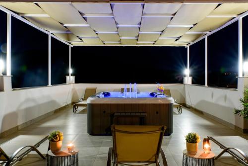 a room with a table and chairs on a balcony at Apartment Solis (****) in Prgomet