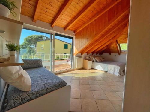 a bedroom with a bed and a large window at Appartamento Moneglia in Moneglia