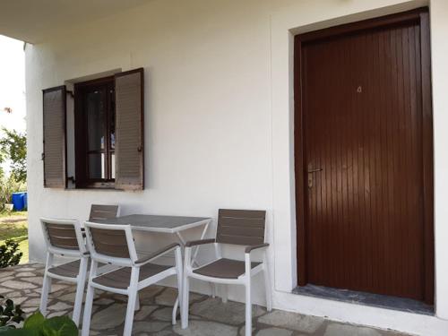 a table and chairs sitting next to a building at Skiathos Maria Apartments in Skiathos Town