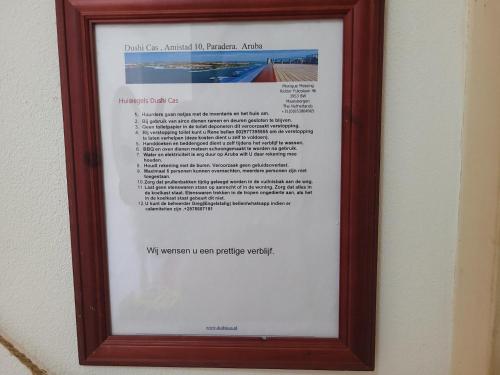 a picture of a sign in a frame on a wall at Cozy home under the Sun with Swimmingpool in Paradera