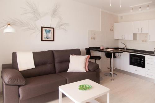 a living room with a couch and a table at Apartamentos Thaisay LUZ DEL MAR II in Puerto del Carmen