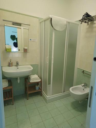 a bathroom with a sink and a shower and a toilet at Lo Zizzolo- Bed&Breakfast in Marina di Campo