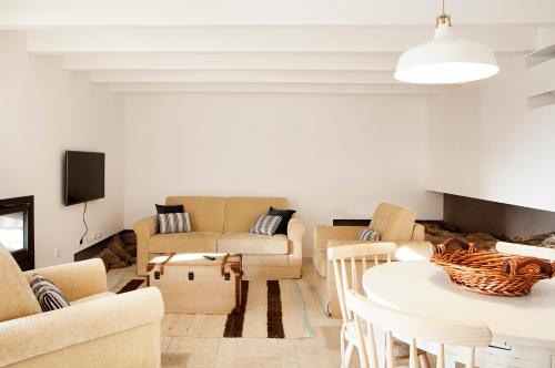 a living room with a table and chairs at Casas de Vale de Lobo in Mirandela