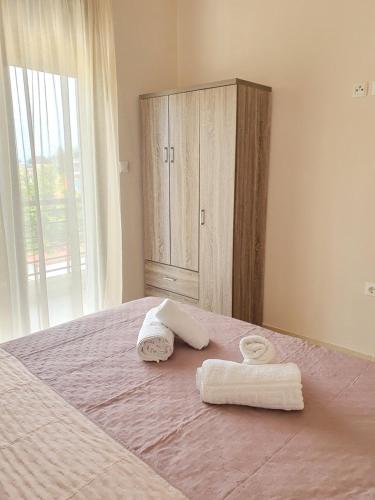 a bedroom with two towels on a bed at Elena Apartments in Asprovalta