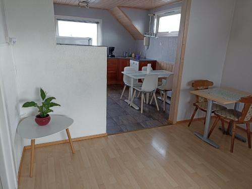 a kitchen and dining room with a table and chairs at FeelHome One bedroom apartment Vidarsveg in Tromsø