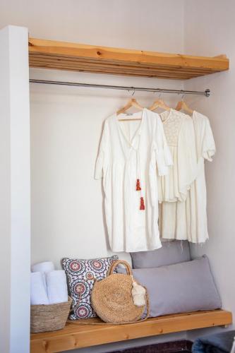 a closet with a shelf with a white shirt and towels at Phaos in Kyparissia