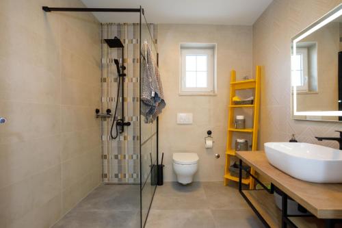 ein Badezimmer mit Dusche, Waschbecken und Toilette in der Unterkunft New&Modern apartment Dora in Vrh