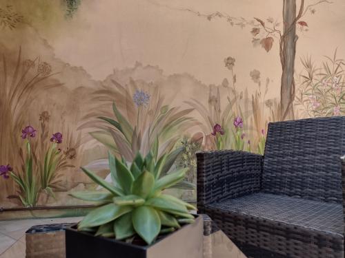 a wall with a mural of flowers and plants at Casa Gabri in Toscolano Maderno