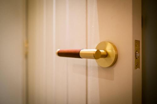 a door with a wooden door knob on it at Craig's Suites Windermere in Windermere