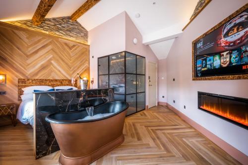 a bathroom with a black tub and a bedroom at Craig's Suites Windermere in Windermere