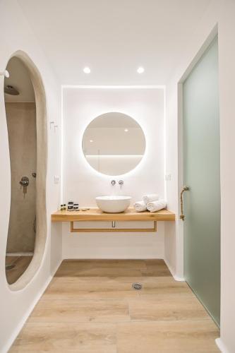 a bathroom with a sink and a mirror at Villa Adriana Hotel in Agios Prokopios