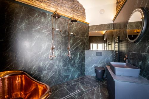 a bathroom with a copper tub and a sink at Craig's Suites Windermere in Windermere