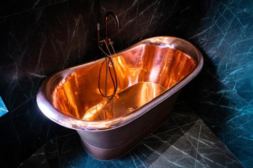 a copper bath tub sitting on top of a counter at Craig's Suites Windermere in Windermere