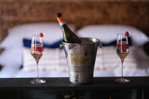 a bottle of wine in a bucket next to two glasses at Craig's Suites Windermere in Windermere