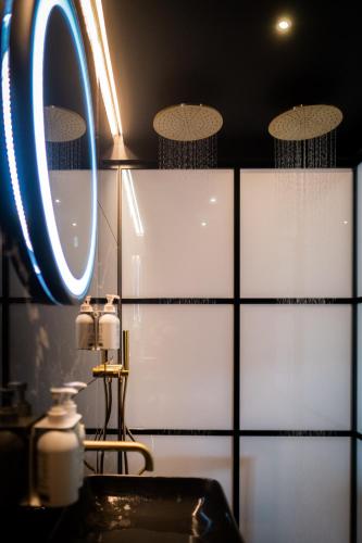 a bathroom with a sink and a mirror at Craig's Suites Windermere in Windermere