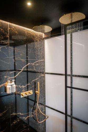 a bathroom with two shower doors and two lights at Craig's Suites Windermere in Windermere