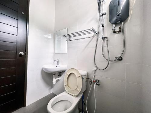 a bathroom with a toilet and a sink at Villa near SPICE Arena 8BR 45PAX V KTV Pool Table and Kids Swimming Pool in Bayan Lepas