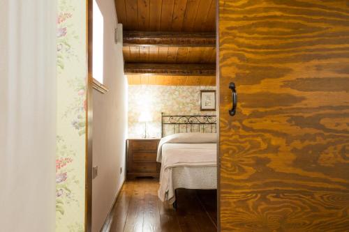 a bedroom with a bed and a wooden wall at Terrazza sul Parco in Modica