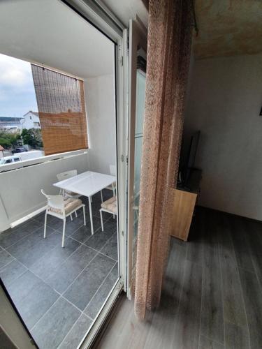 a balcony with a table and a table at 6 M, 50 m do plaže in Barbat na Rabu