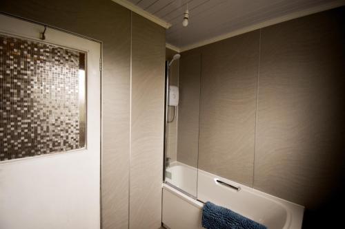 a bathroom with a sink and a mirror at Jovie Apartment in Stornoway