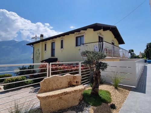 a house with a bench in front of it at Village Hotel Lucia in Tremosine Sul Garda