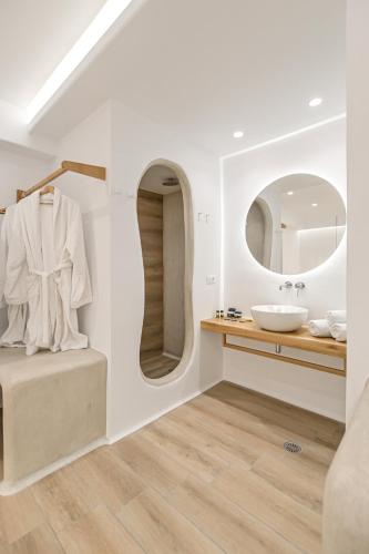 a bathroom with a sink and a mirror at Villa Adriana Hotel in Agios Prokopios