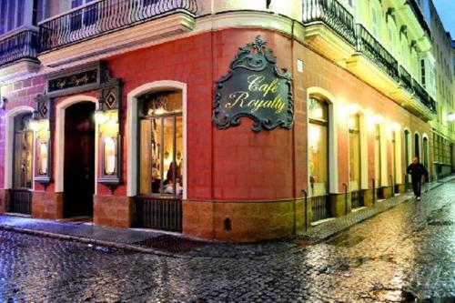 a person walking past a store on a street at Suite Catedral Little Apartments in Cádiz
